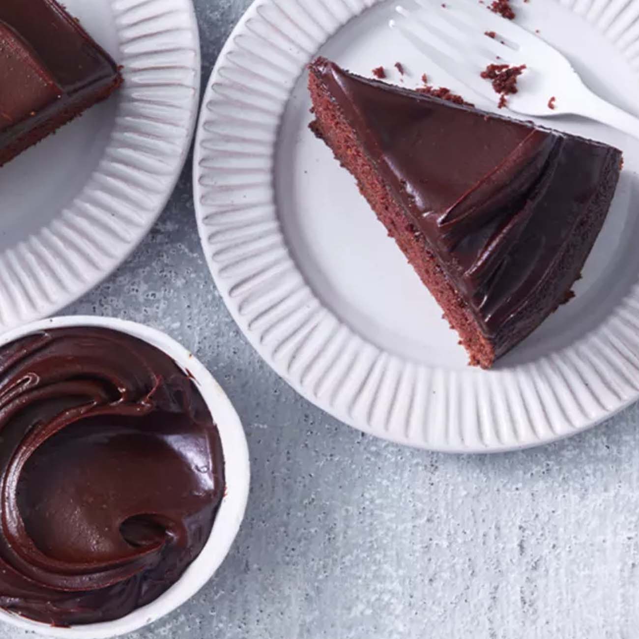 A slice of rich chocolate mud cake with smooth chocolate ganache frosting.